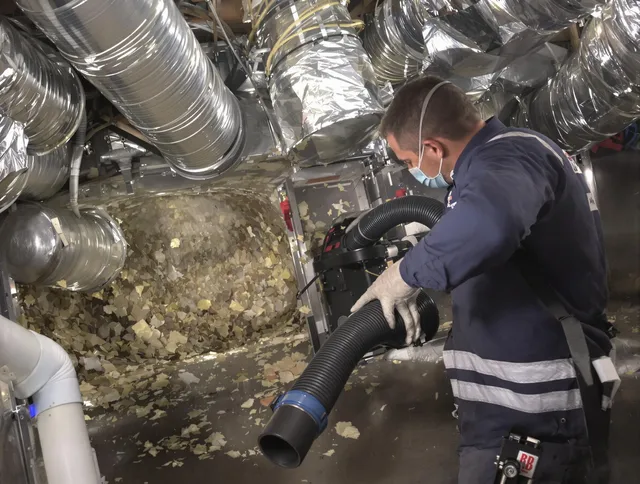 Lynnfield Air Duct Cleaning specialist operating negative pressure cleaning equipment for thorough duct maintenance in Lynnfield