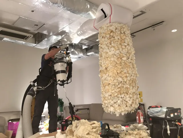 Lynnfield Air Duct Cleaning technician performing precision vacuum insulation removal in a residential property in Lynnfield